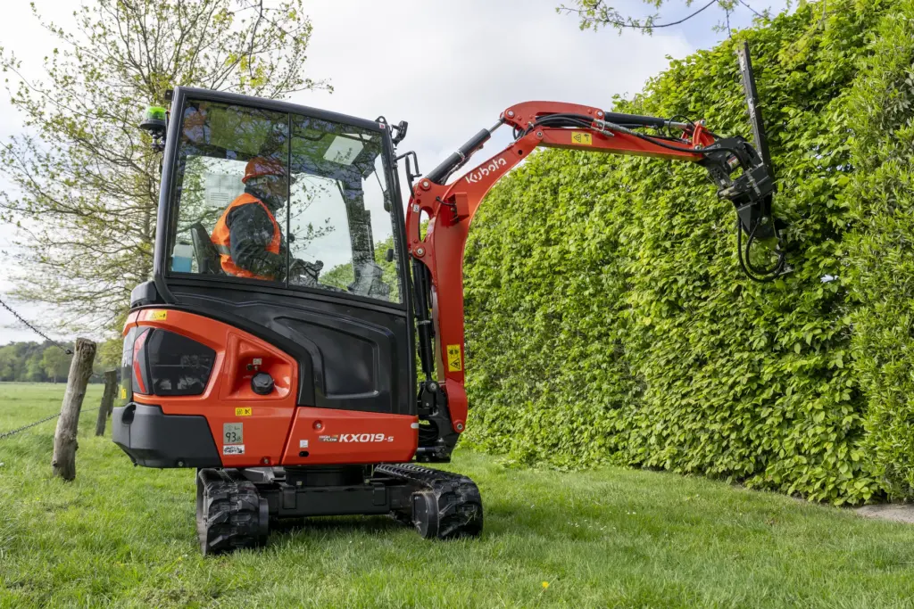 Kubota KX019-5 Kompaktbagger bei der Heckenpflege